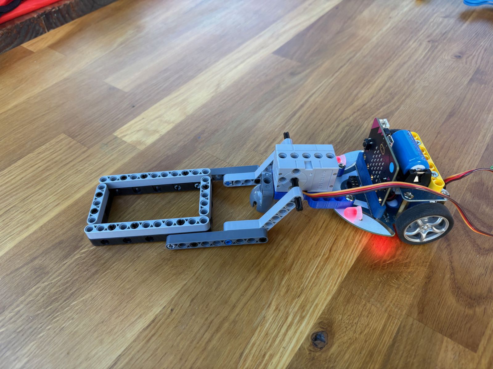 Student-built wheeled robot on a wooden floor