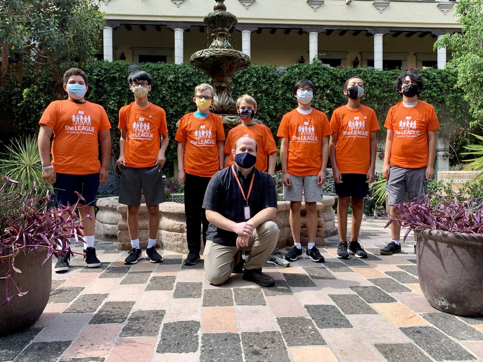 League robotics team in orange shirts